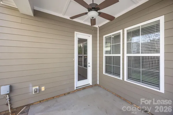a view of a backyard with wooden fence and a stairs
