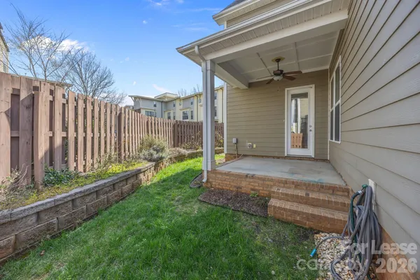 a view of entrance gate of a house with a yard