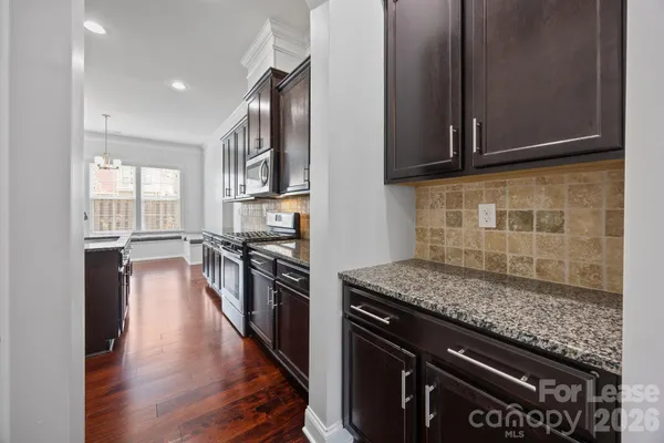 a view of kitchen with cabinets and wooden floor