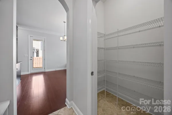 an empty room with fan and windows