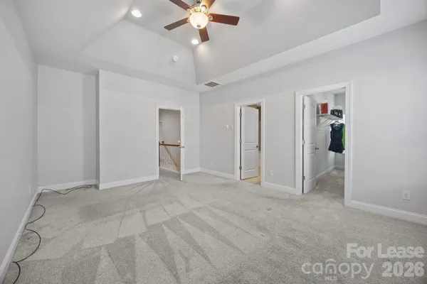 a spacious bathroom with a granite countertop double vanity sink a mirror and a bathtub