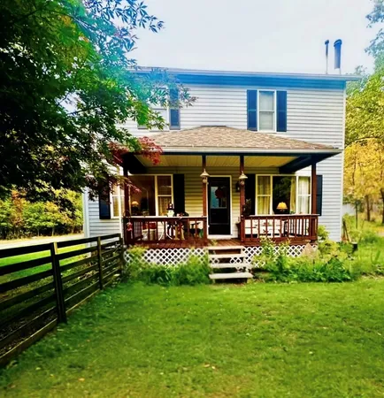 a front view of a house with a yard table and chairs