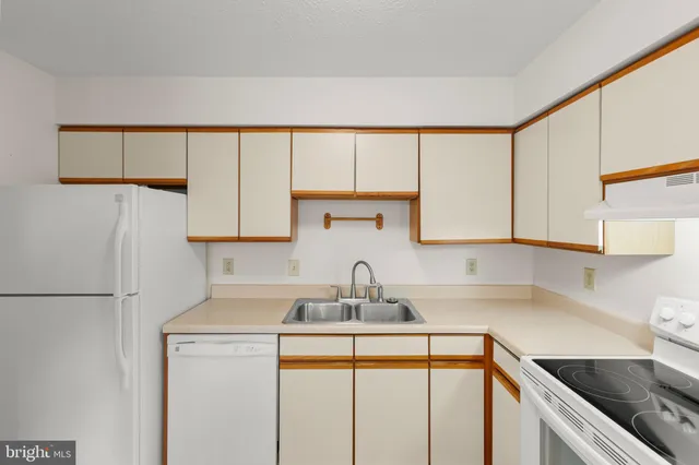 a kitchen with a sink cabinets and a window