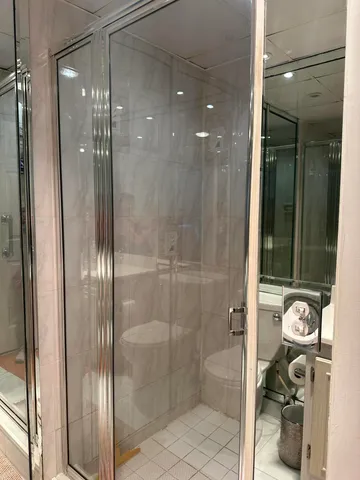 a bathroom with a glass shower door