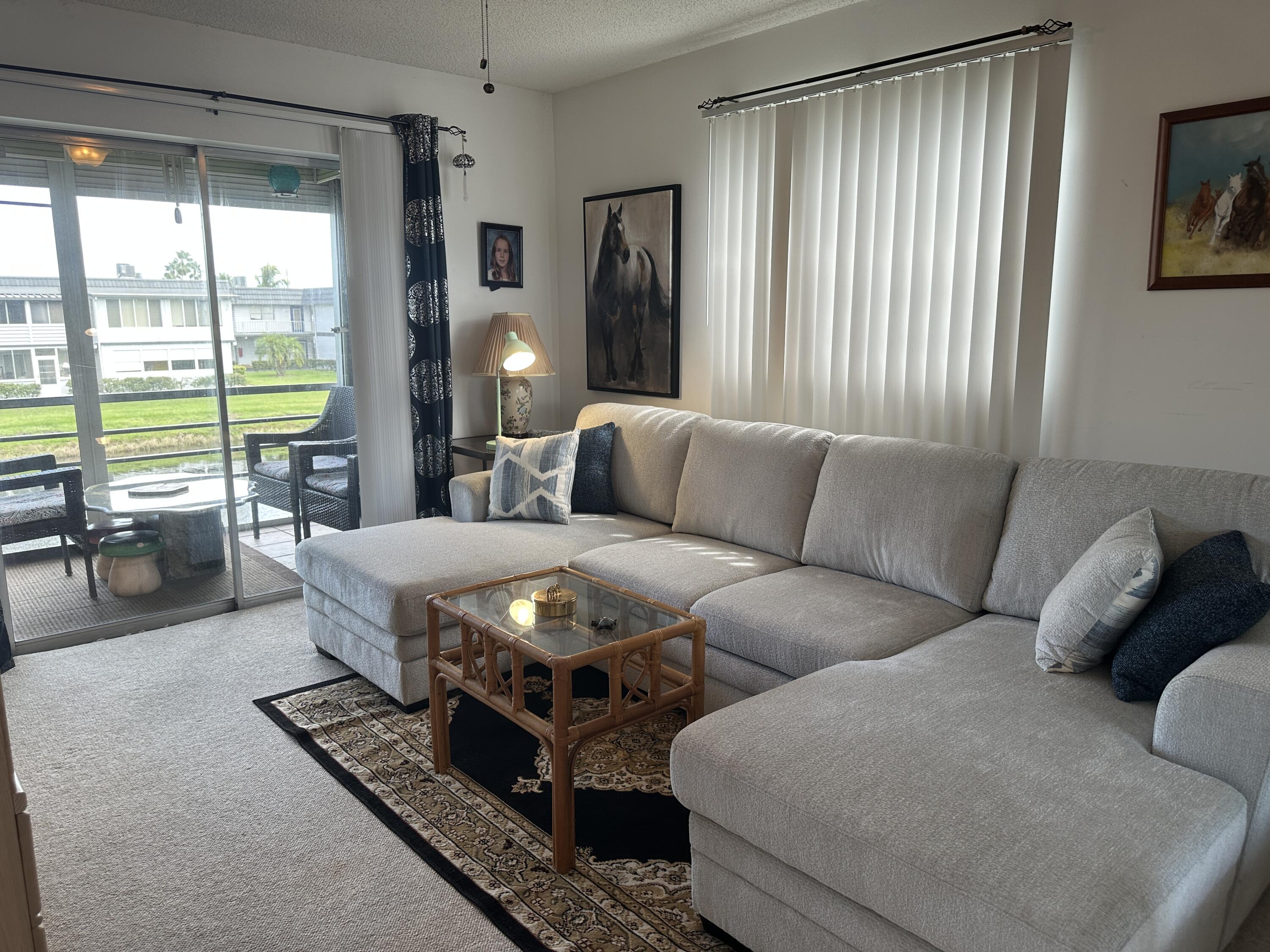 415 Saxony Way Delray Beach, FL 33446 - Photo 12 of 23 a living room with furniture and a large window