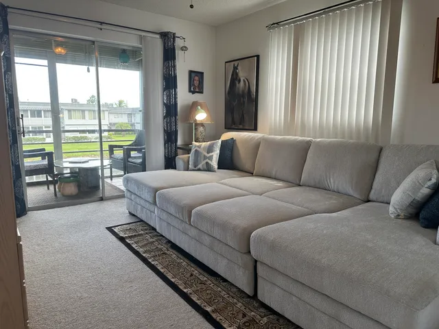 a living room with a large bed and a large window