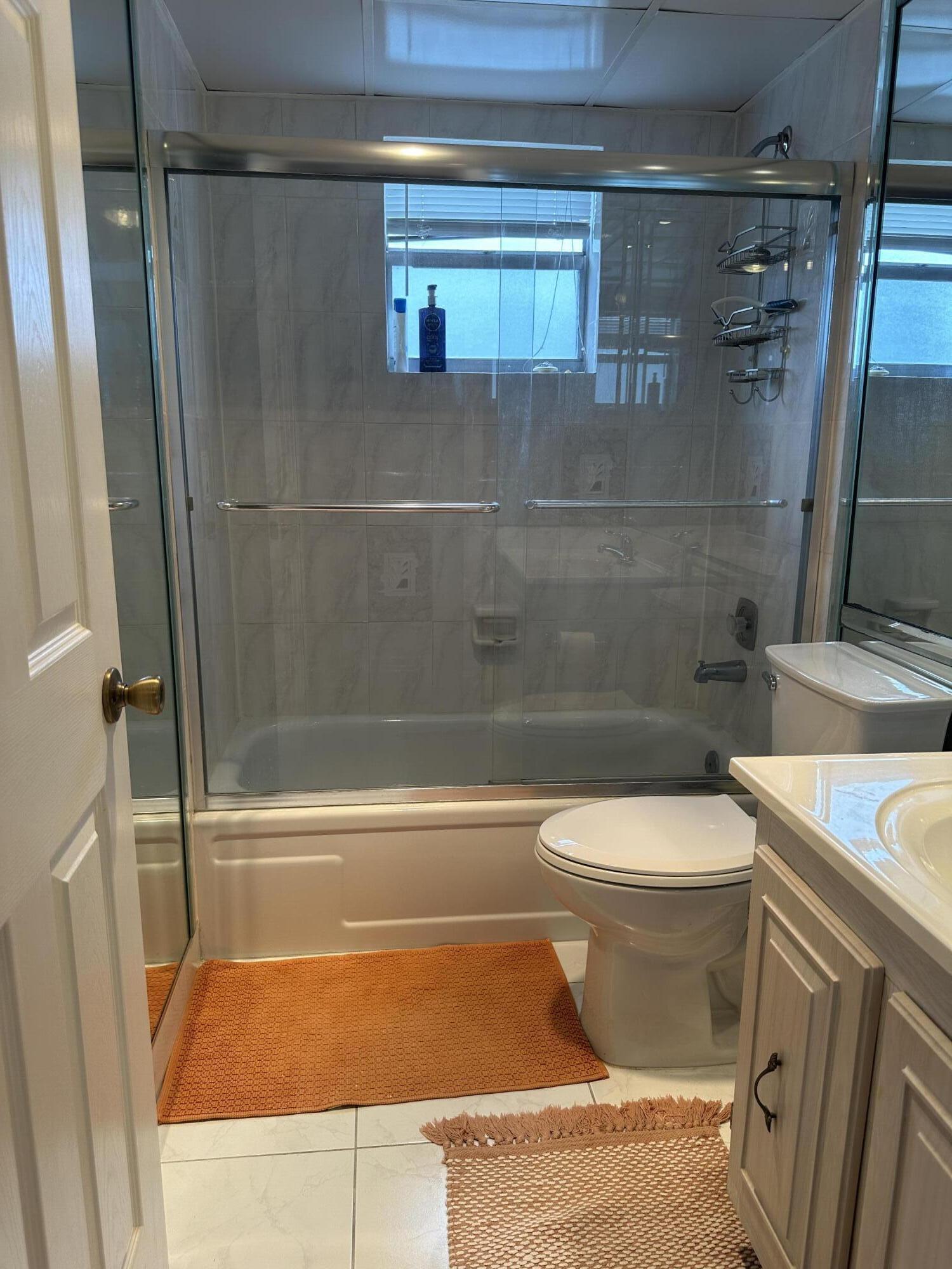 415 Saxony Way Delray Beach, FL 33446 - Photo 14 of 23 a bathroom with a toilet and a shower