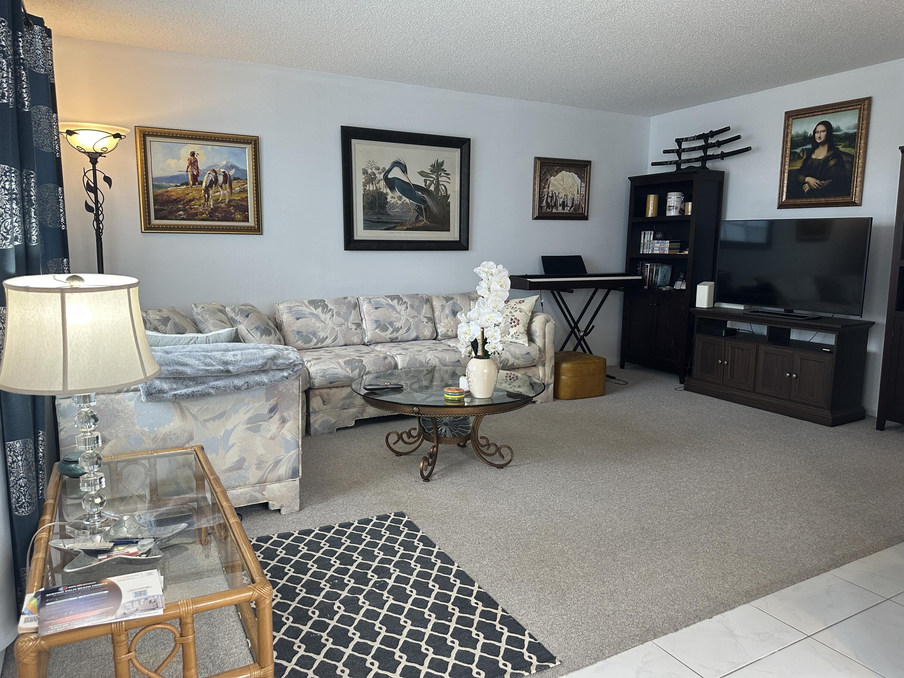 415 Saxony Way Delray Beach, FL 33446 - Photo 2 of 23 a living room with furniture and a flat screen tv