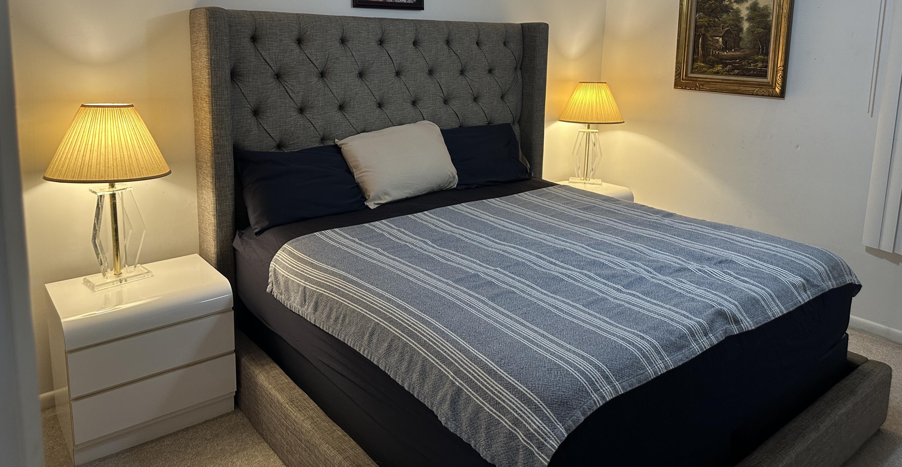 415 Saxony Way Delray Beach, FL 33446 - Photo 7 of 23 a bedroom with a bed and lamp with the wall