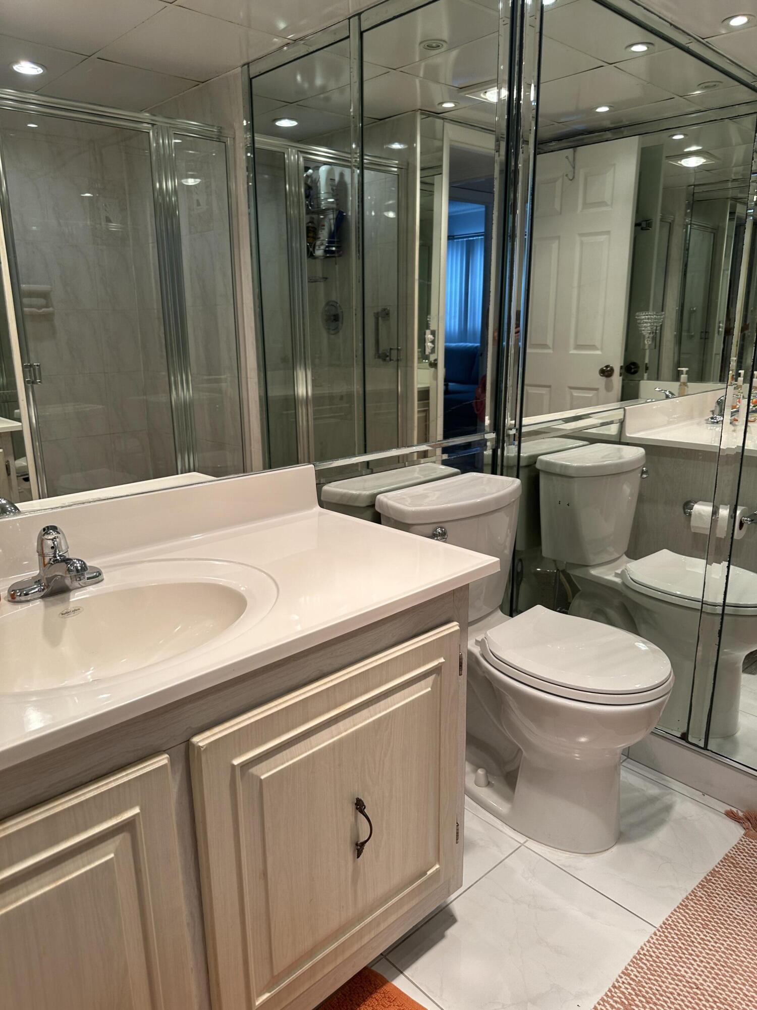 415 Saxony Way Delray Beach, FL 33446 - Photo 10 of 23 a bathroom with a sink a toilet and shower
