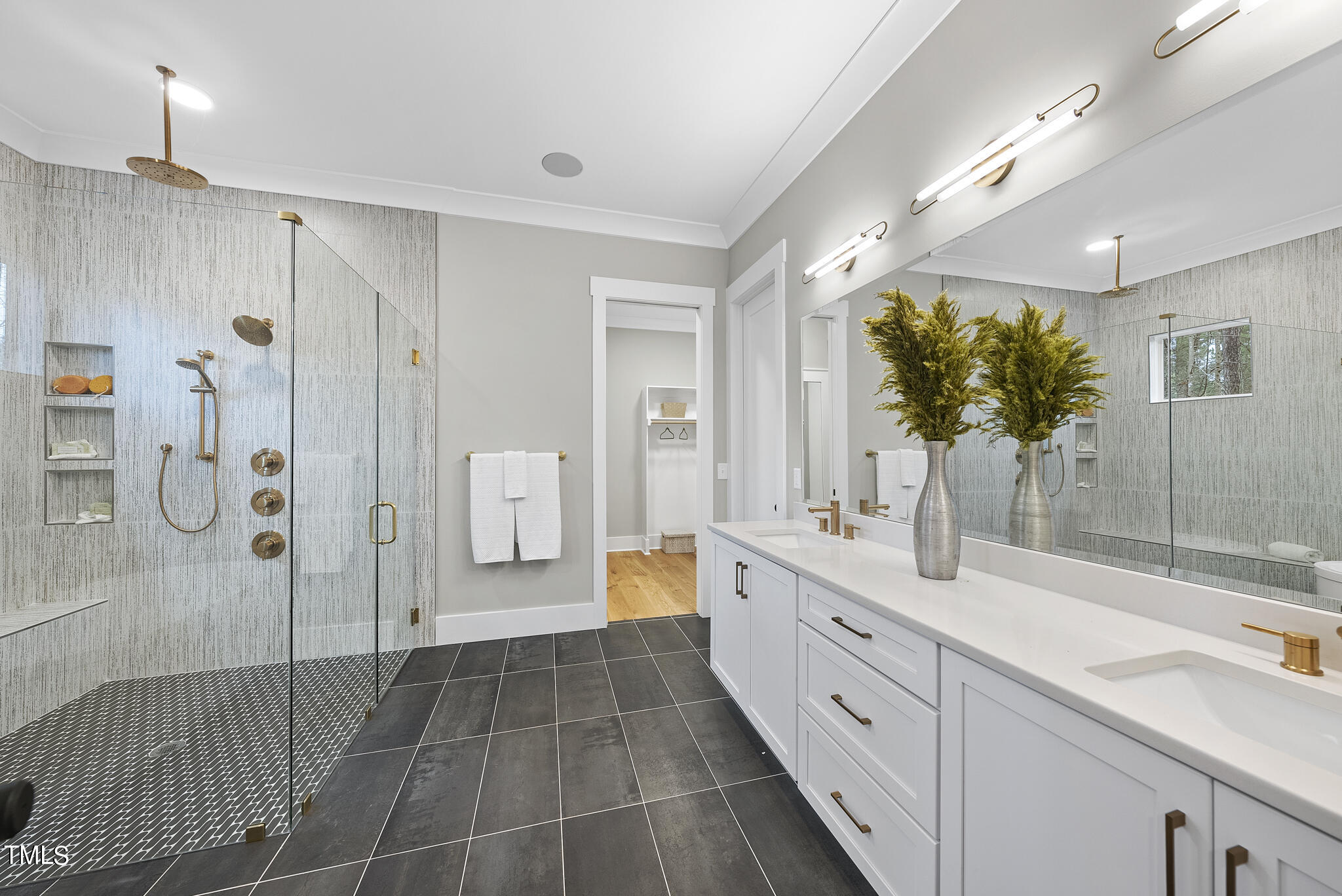 7820 Ailesbury Road Wake Forest, NC 27587 - Photo 11 of 35 a spacious bathroom with a double vanity sink a large mirror and shower