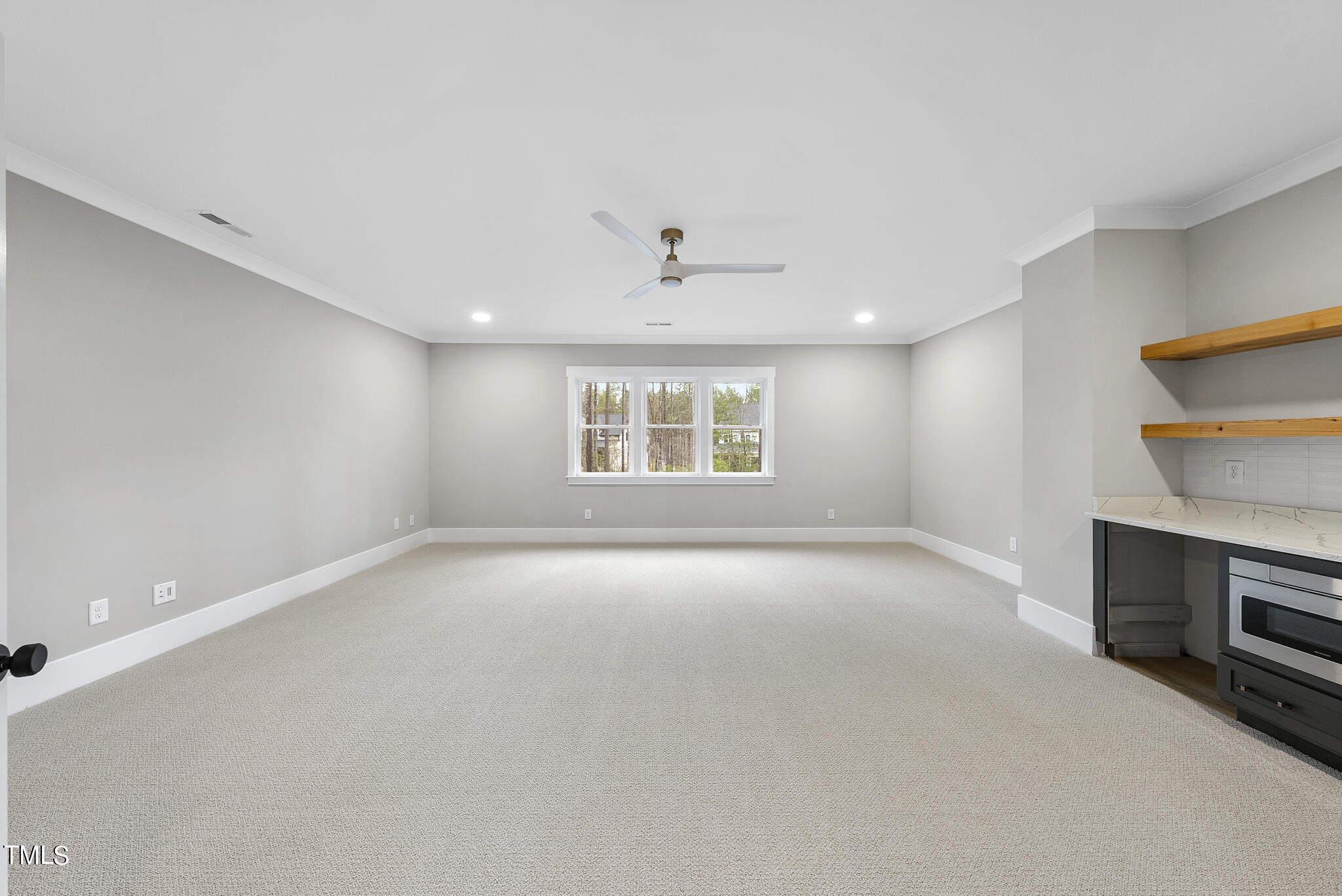 7820 Ailesbury Road Wake Forest, NC 27587 - Photo 22 of 35 a view of an empty room with a window and a kitchen