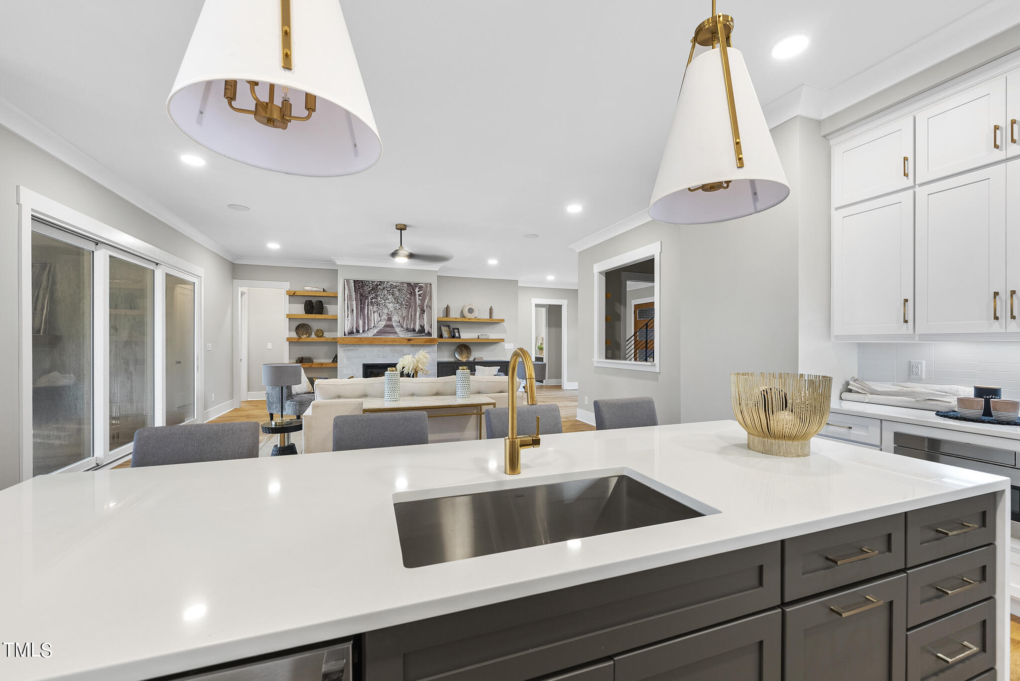 7820 Ailesbury Road Wake Forest, NC 27587 - Photo 4 of 35 a kitchen with a sink dishwasher a stove and white cabinets with wooden floor