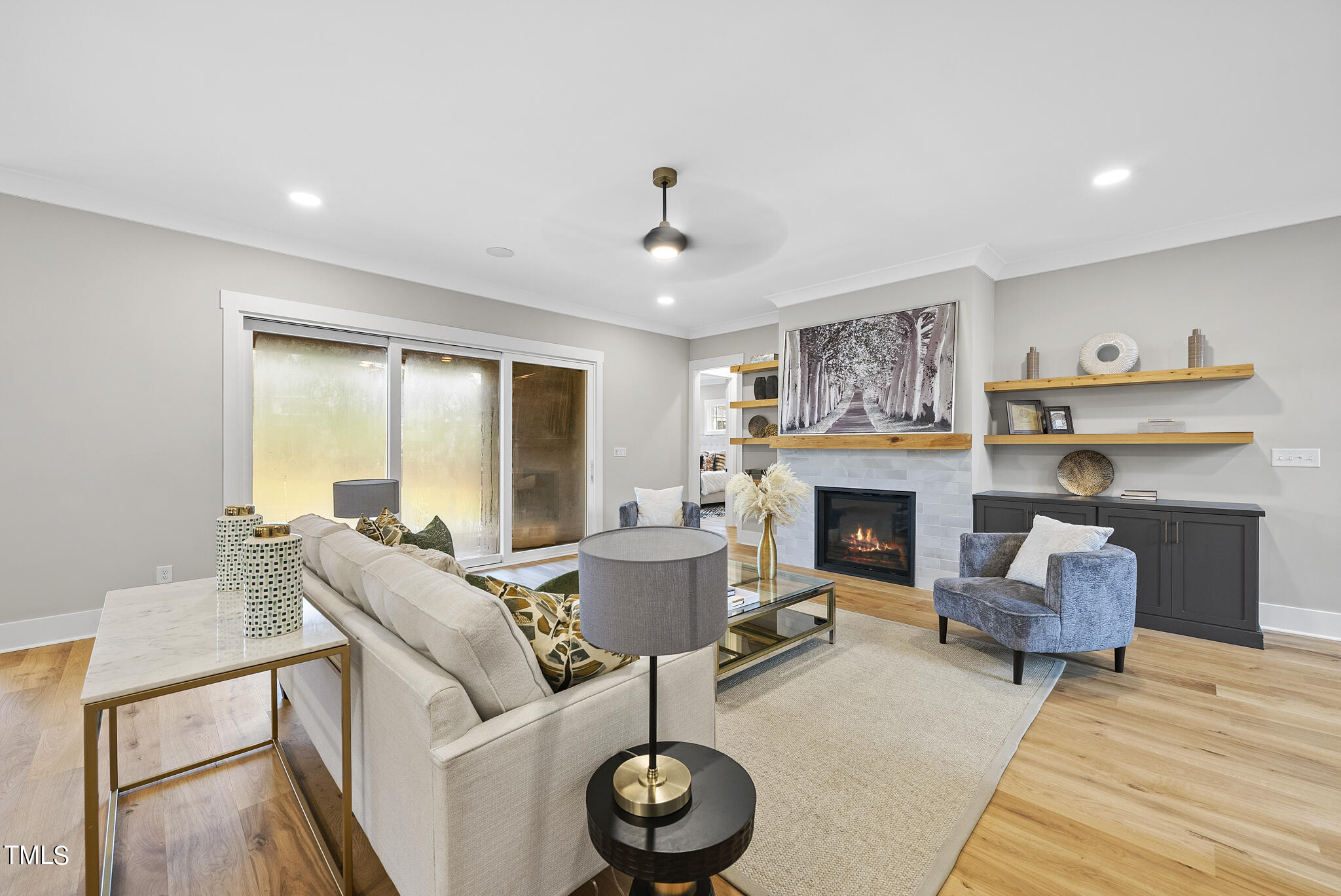 7820 Ailesbury Road Wake Forest, NC 27587 - Photo 7 of 35 a living room with furniture a fireplace and a large mirror
