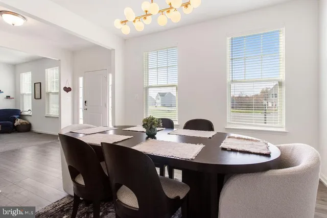 a view of a dining room with furniture and window