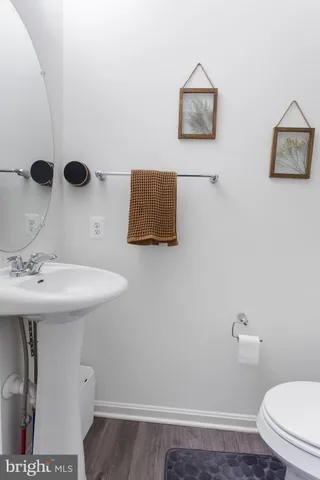a bathroom with a sink a toilet and mirror