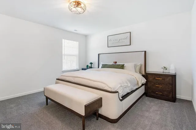 a bed room with a bed and a lamp