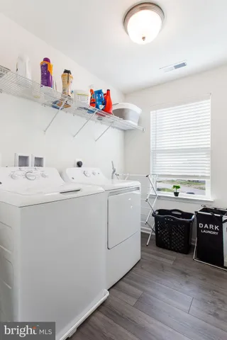 a utility room with sink dryer and washer