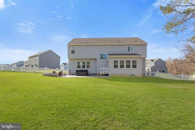 a front view of a house with a garden and deck