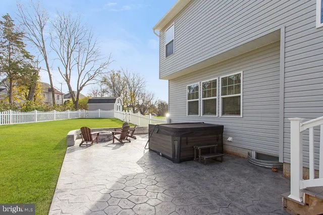 a view of a house with a yard and sitting area
