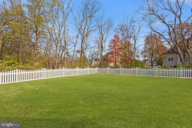 a view of a deck with a big yard and large trees