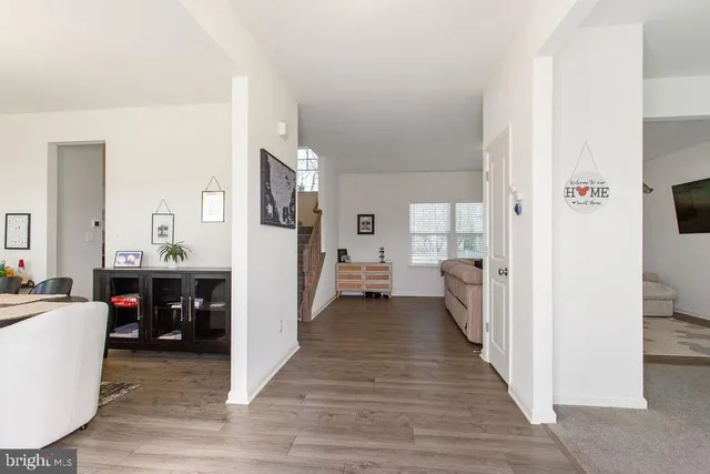 a view of living room with furniture and wooden floor