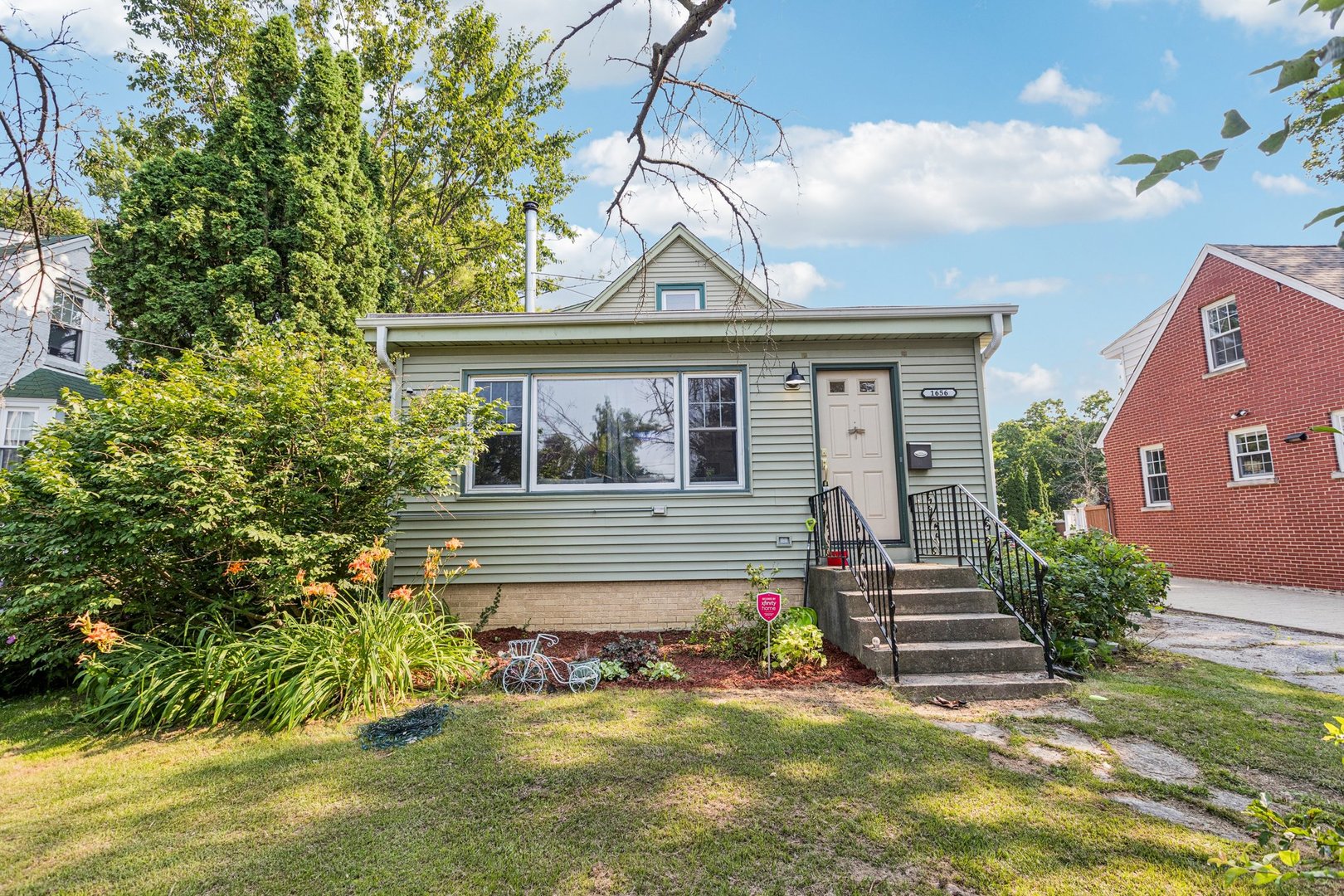 1656 Harding Road Northfield, IL 60093 - Photo 1 of 14 a front view of a house with a yard