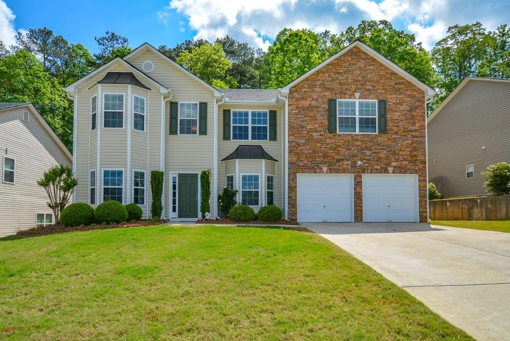 293 Holbrook Drive Dallas, GA 30132 - Photo 1 of 1 a front view of a house with a yard and garage