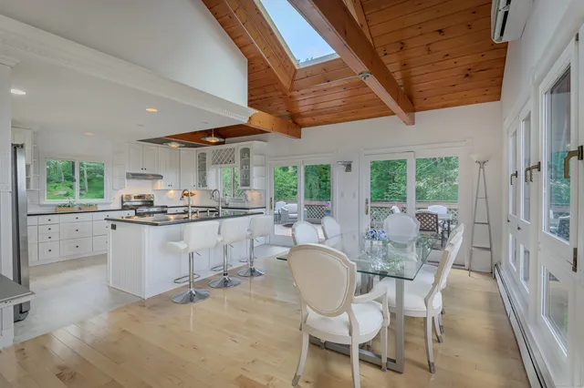 a kitchen with a table chairs refrigerator and cabinets