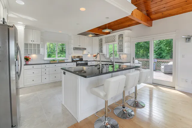 a dining table with chairs and window