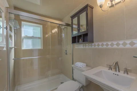 a bathroom with a sink toilet and shower