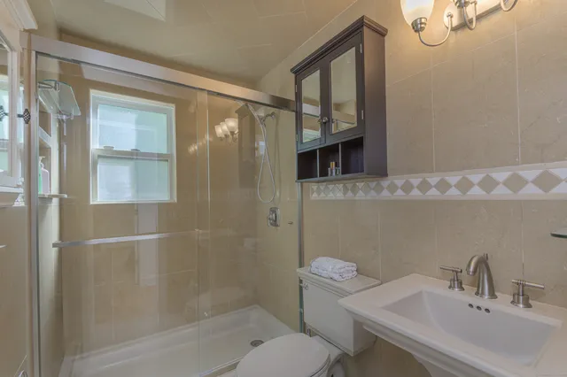 a bathroom with a sink toilet and shower