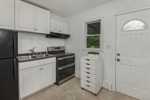 a kitchen with appliances cabinets and a window