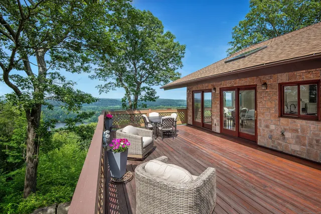 a terrace with outdoor seating and trees
