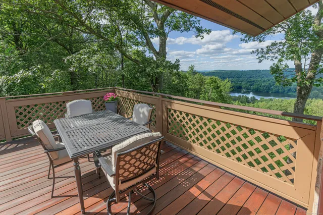 a view of balcony with wooden floor and outdoor seating