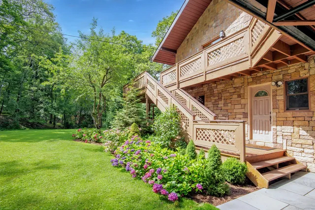 a view of a street with potted plants and the wall