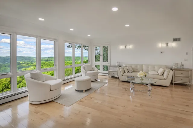 a living room with furniture and large windows