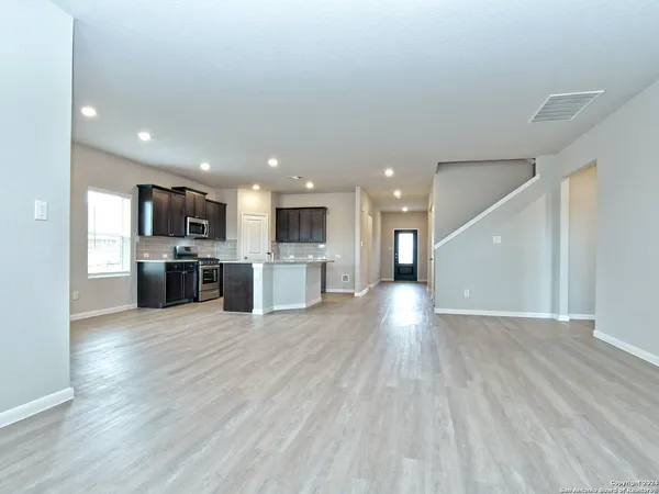 a kitchen with stainless steel appliances granite countertop a sink stove and cabinets
