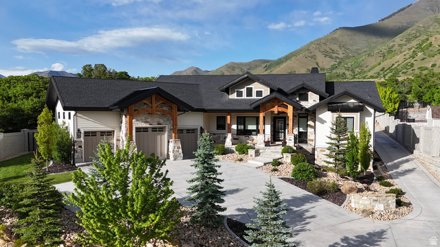 3167 South Mapleton Estates Drive Mapleton, UT 84664 - Photo 2 of 42 Modern inspired farmhouse with stone siding, driveway, a garage, a mountain view, and a chimney