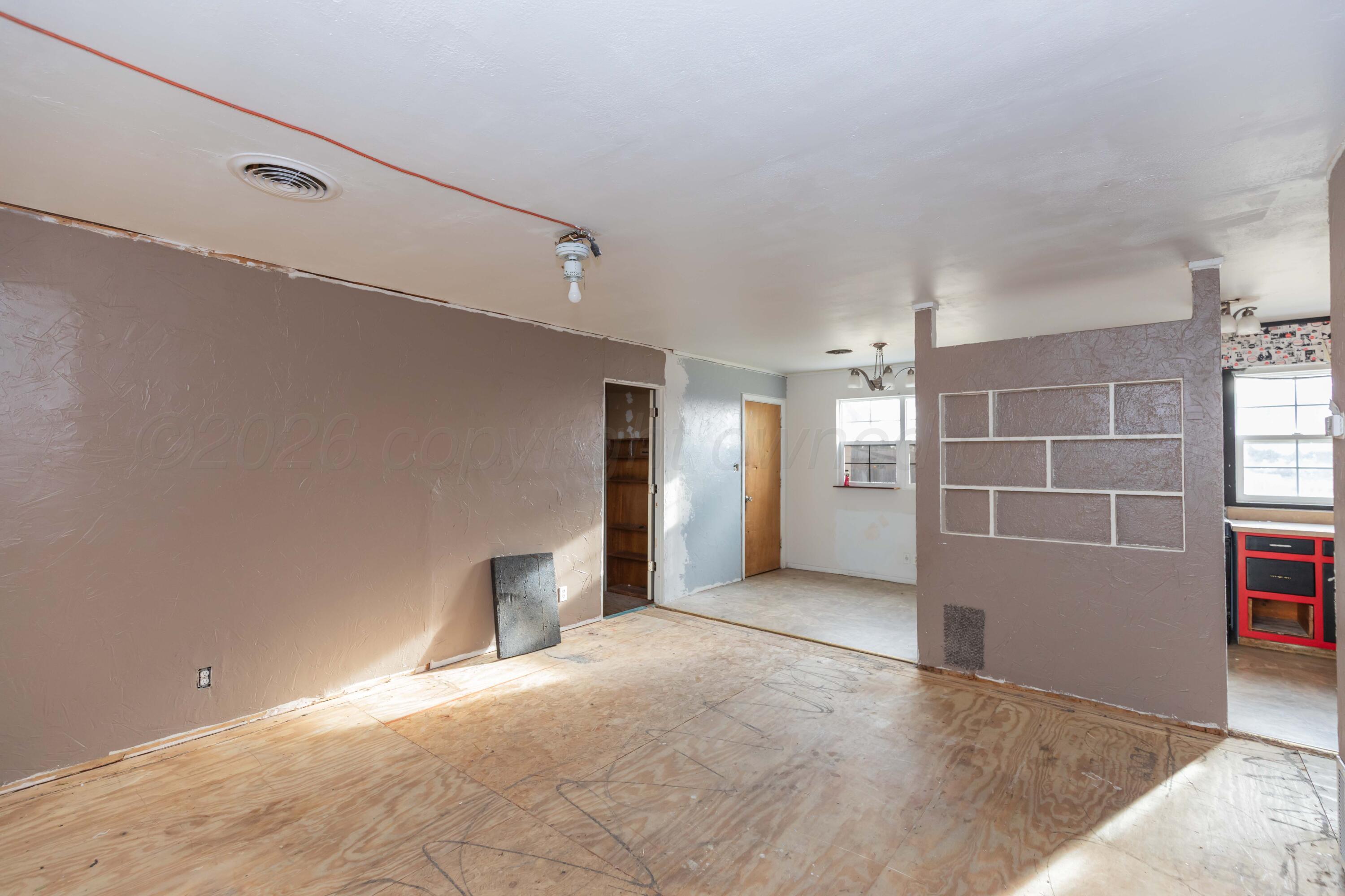 107 Inverness Street Borger, TX 79007 - Photo 5 of 22 a view of a big room with closet and windows