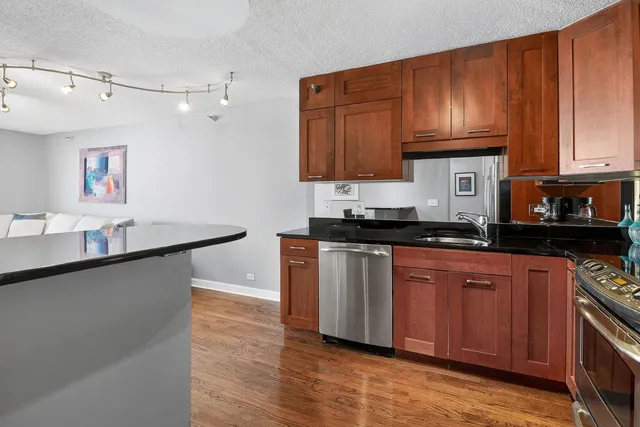 a bedroom with a bed and a dresser next to a window