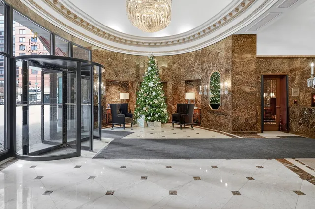 a view of entryway with brick walls and chandelier