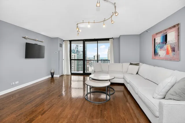 a living room with furniture and kitchen view