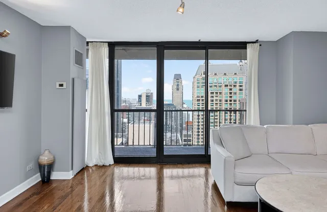 a kitchen with granite countertop a refrigerator stove and wooden floor