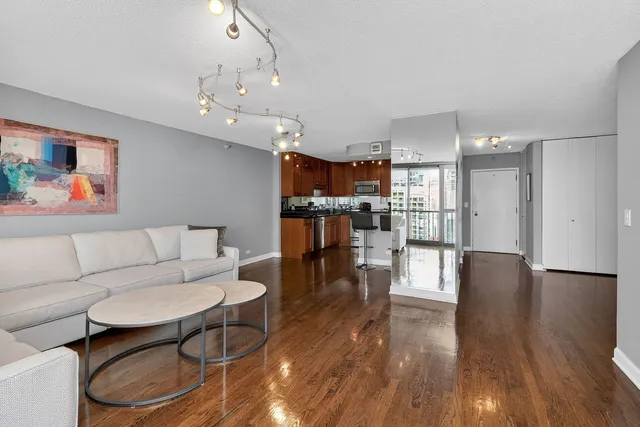 a kitchen with granite countertop a sink cabinets and stainless steel appliances