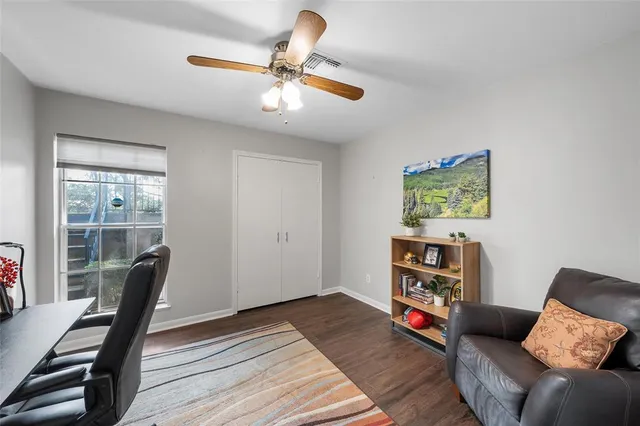 a living room with furniture and a wooden floor