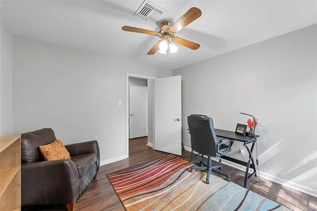 a work room with furniture and wooden floor