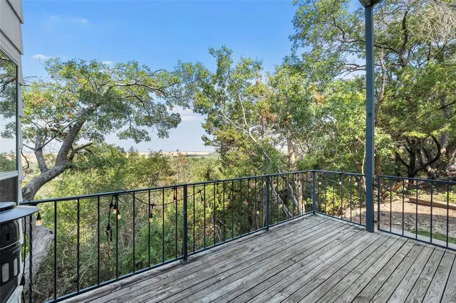 a view of balcony with wooden floor and fence