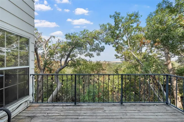 a view of a balcony and trees
