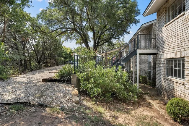 a view of a house with a tree in the yard